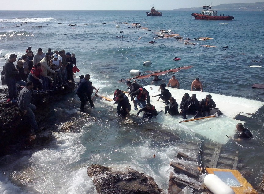 Migrants come to shore at Zefyros beach on the Greek island of Rhodes after their sailboat capsized on April 20. Most of the migrants managed to swim safely to the beach with the assistance of locals.